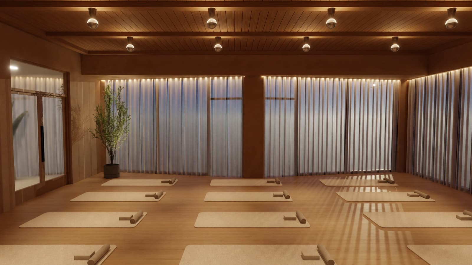 Yoga mats and bolsters laid out on a warm wood floor beneath a slatted timber ceiling in the movement studio at Composure Club